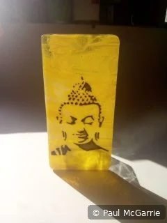 Buddha in Amber, fused glass artwork by Paul McGarrie